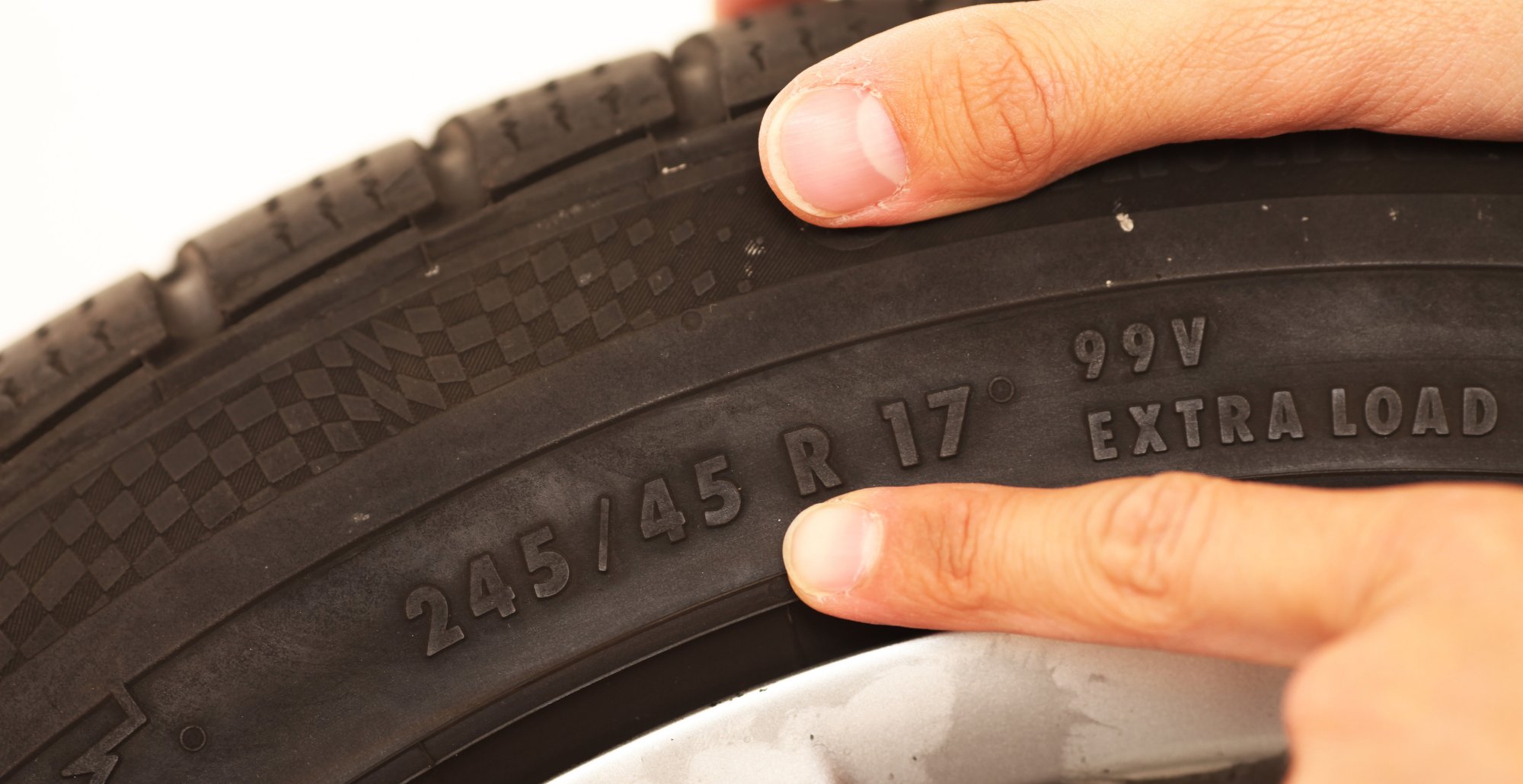 Close-up of tire sidewall showing 245/45 R17 size and extra load markings.