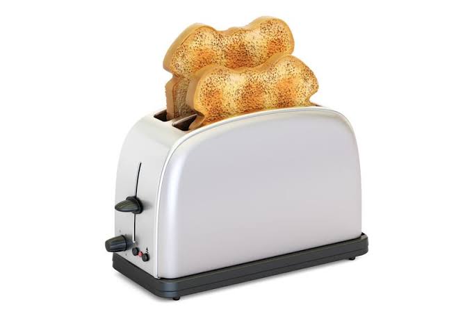 White two-slice toaster with toasted bread on a plain background.