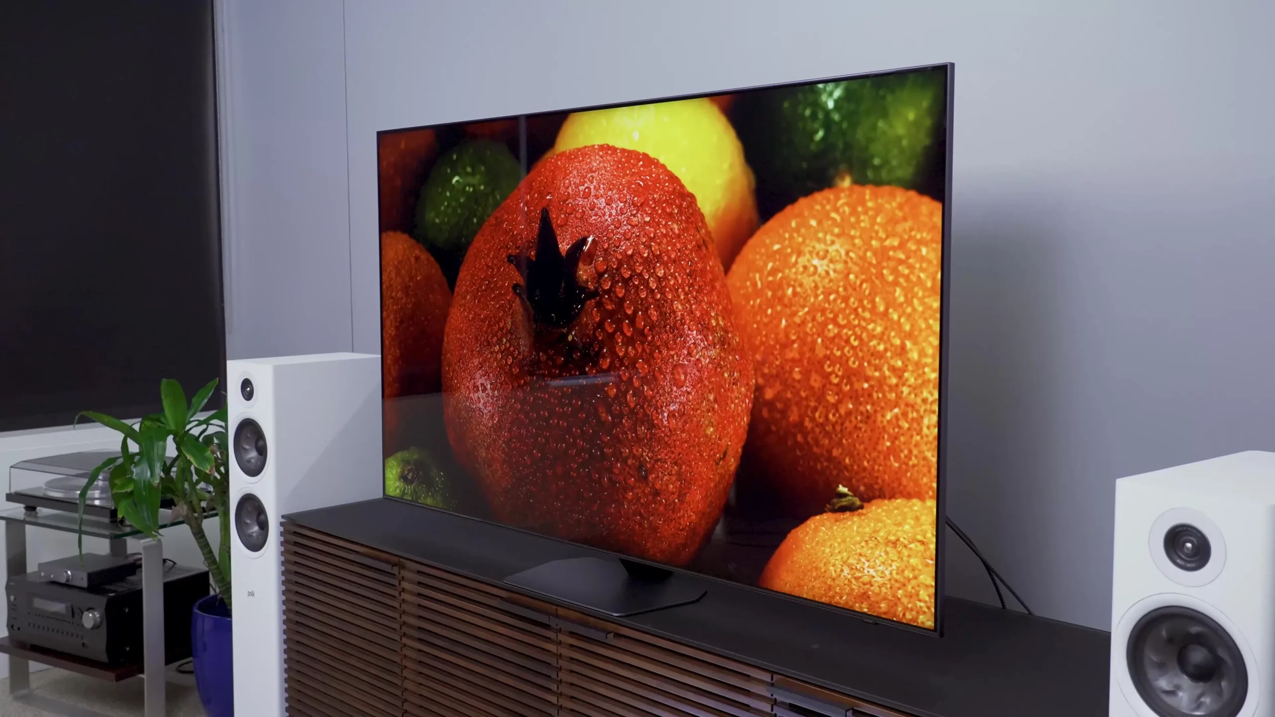 OLED television displaying vivid fruit colors in a modern home entertainment setup 