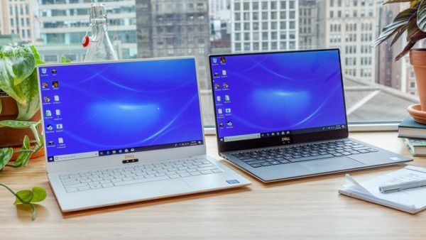 Two Dell laptops displayed side by side on a desk