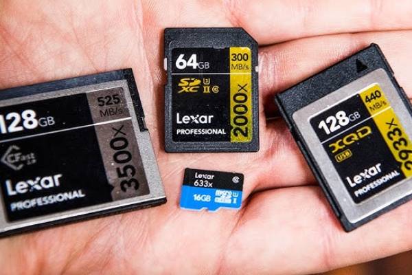 SD and microSD memory cards with 64GB and 128GB capacities held in hand 