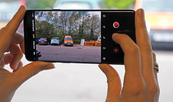 Smartphone camera recording video in landscape mode outdoors