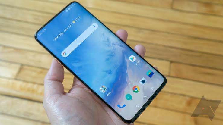Android smartphone held in hand showing a nearly bezel-less display