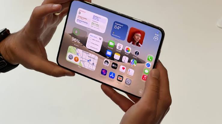 Foldable iPhone concept held in landscape mode with iOS interface