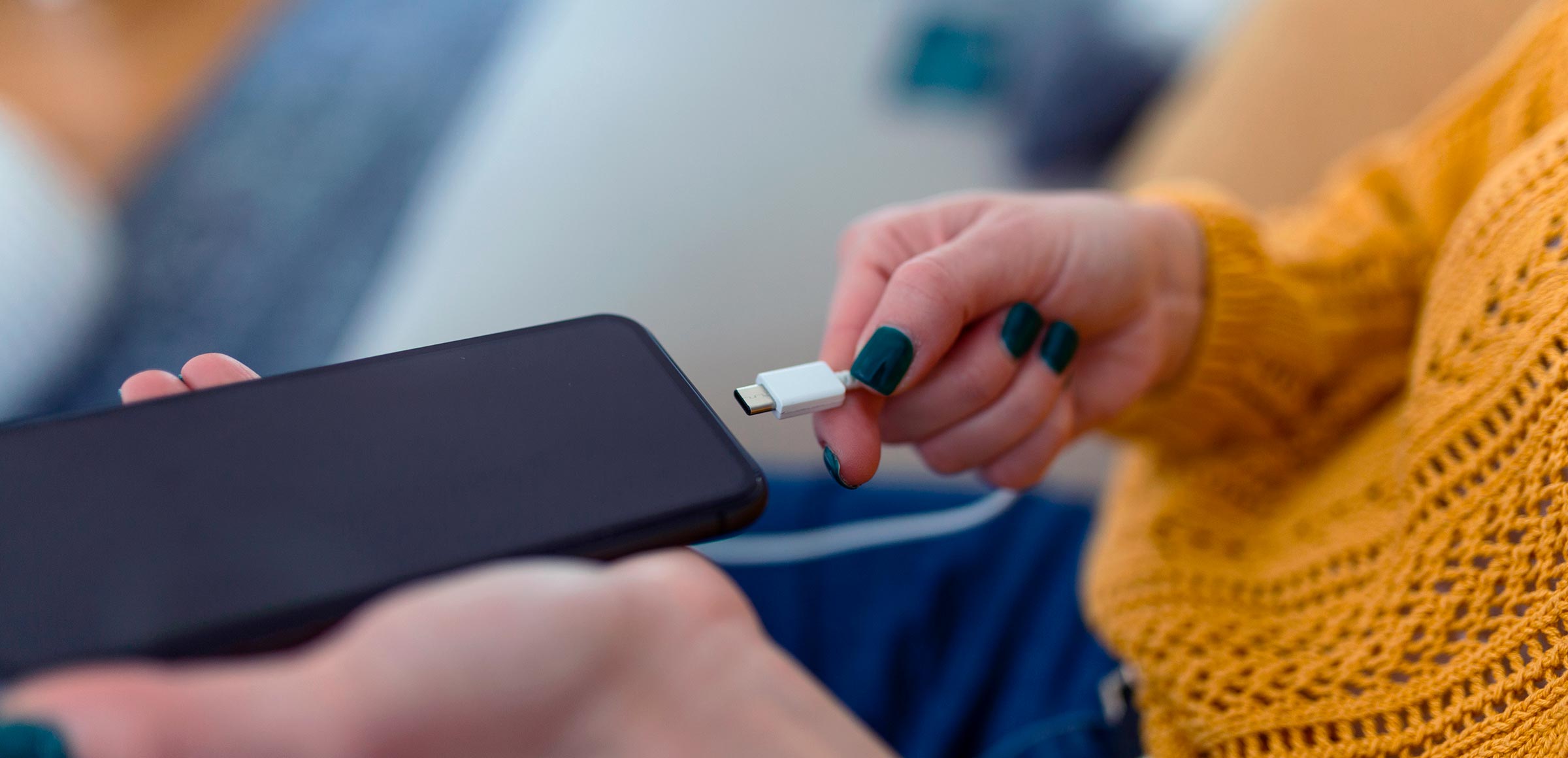 Connecting a USB-C charging cable to a smartphone
