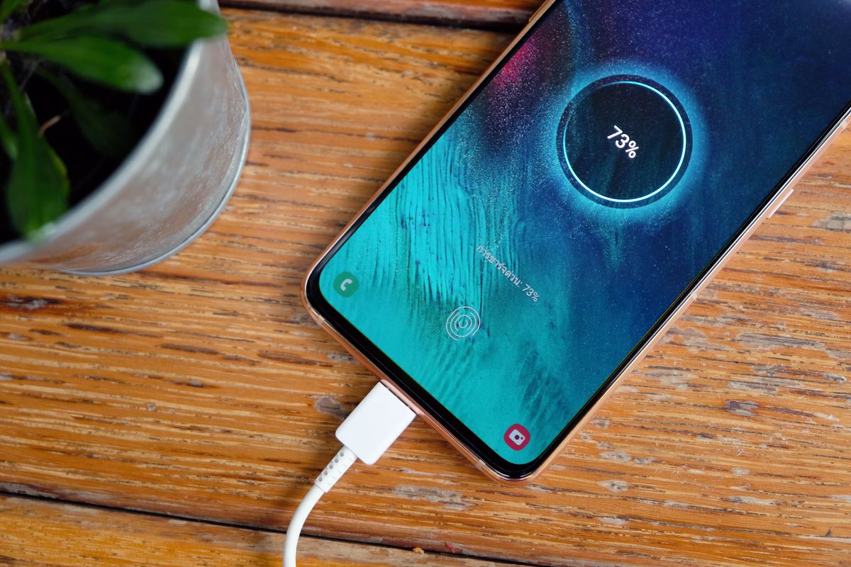 Smartphone charging at 73 percent with a wired charger
