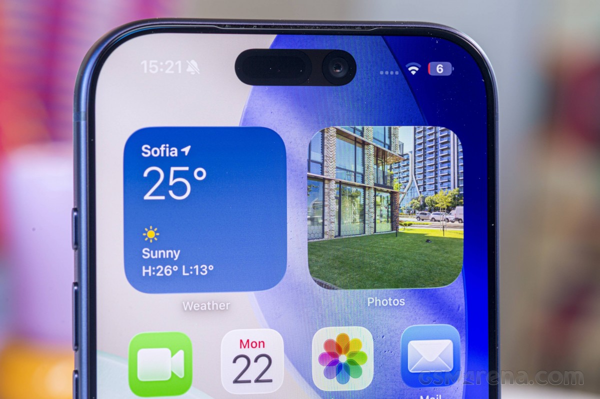iPhone display showing Dynamic Island, weather widget, and Photos app