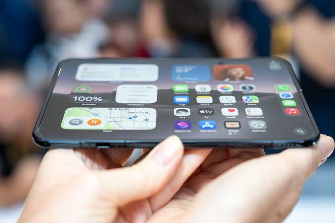 Foldable iPhone concept displaying iOS apps on a wide flexible screen