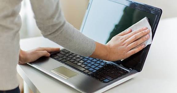 Cleaning a laptop screen with a soft microfiber cloth