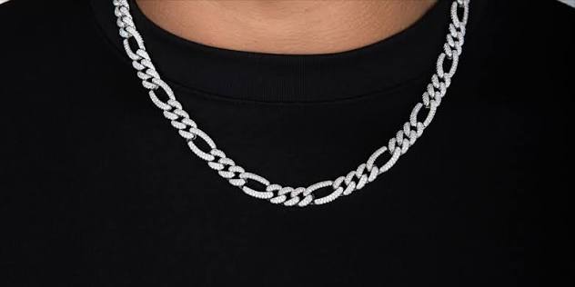 Figaro-style chain necklace worn with a black shirt