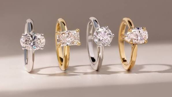 White and yellow gold diamond rings displayed side by side