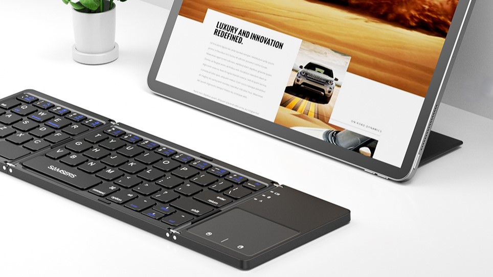 Tablet with detachable keyboard and touchpad on a desk